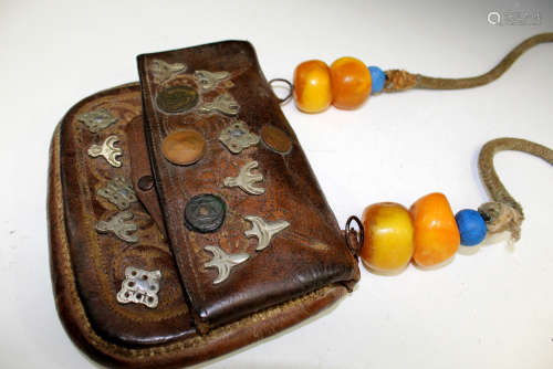 Tibetan leather bag with large amber beads on belt.