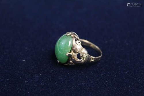 A 14 K gold jadeite ring.