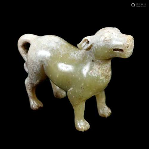 A rare pale green and russet jade carving of a dog.