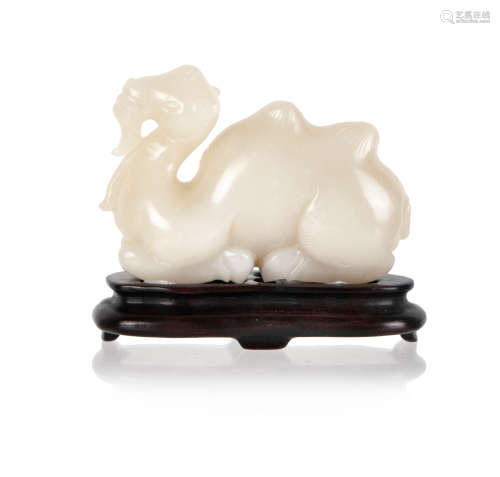 A WHITE JADE CARVED CAMEL ON STAND