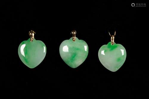 A SET OF THREE HEART-SHAPED JADE 14K YELLOW GOLD PENDANTS