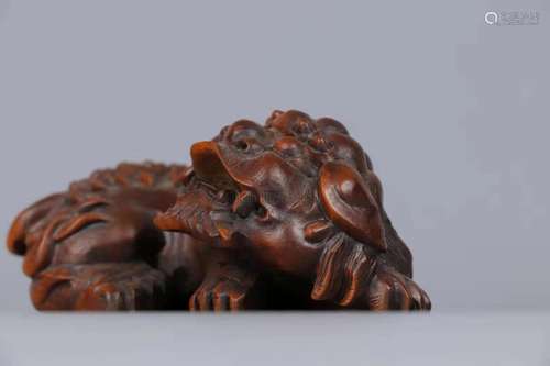 A CARVED WOOD LION