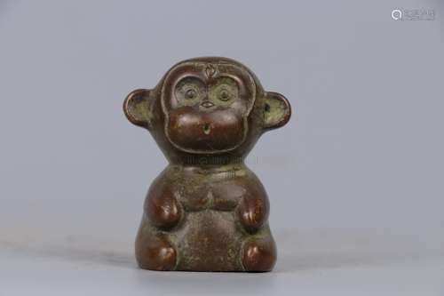 A CARVED BRONZE MONKEY