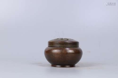 A BRONZE CENSER WITH A PIERCED COVER