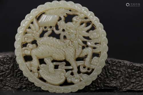 A WHITE JADE OPENWORK 'QILIN' CIRCLE PLAQUE