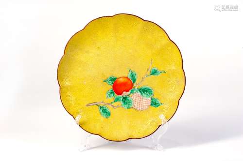 A YELLOW GLAZED DISH WITH FRUIT