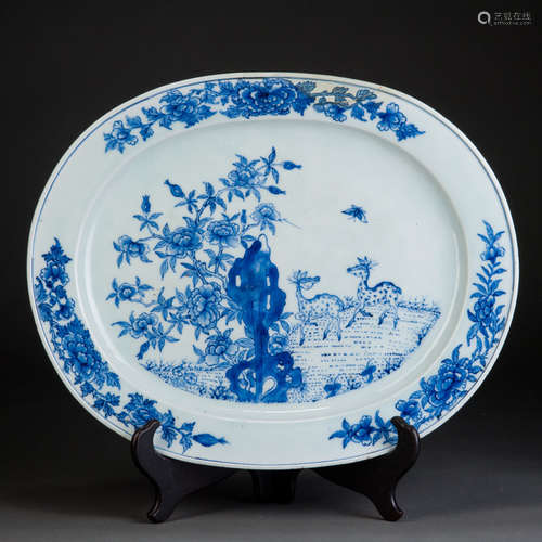 A BLUE AND WHITE DISH WITH TWO DEERS