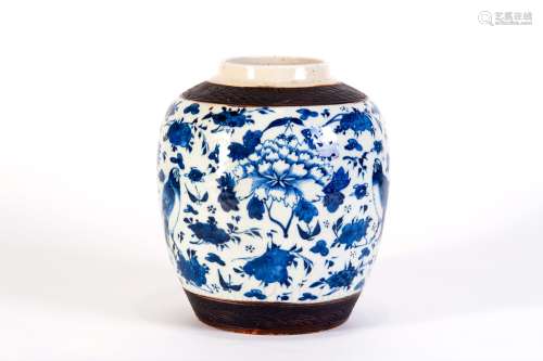 A BLUE AND WHITE JAR WITH BIRDS AND FLOWERS