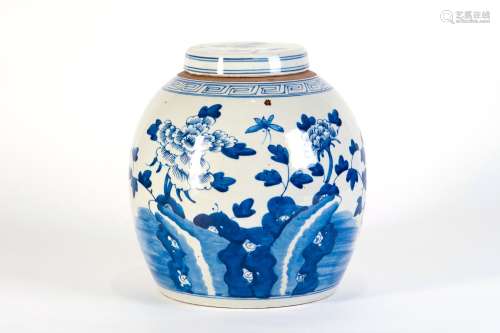 A BLUE AND WHITE COVERD JAR WITH FLOWERS