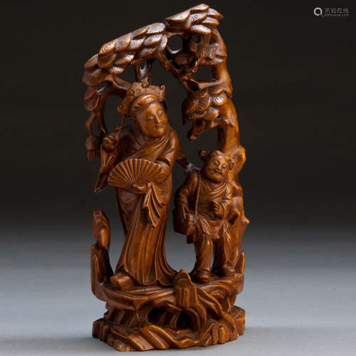 A CARVED WOOD DECORATION
