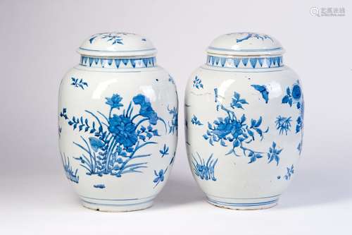 A PAIR OF BLUE AND WHITE JARS WITH FLOWERS