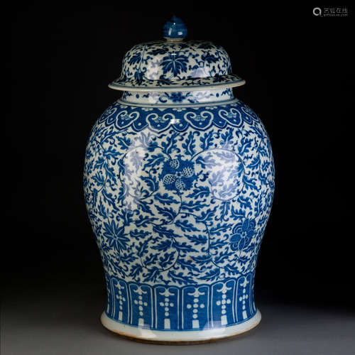 A BLUE AND WHITE JAR WITH FLOWERS