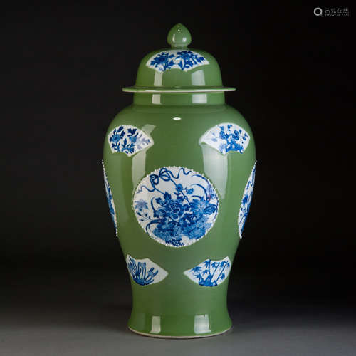 A GREEN GLAZED JAR WITH BLUE AND WHITE FLOWERS