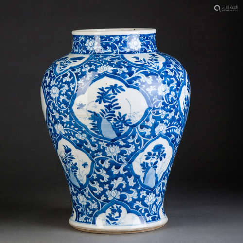 A BLUE AND WHITE JAR WITH FLOWERS