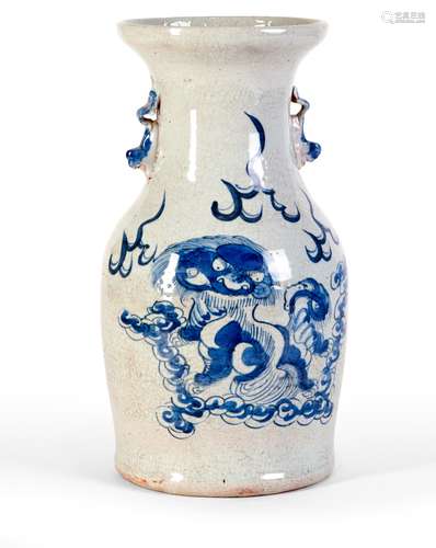 A BLUE AND WHITE VASE WITH LIONS