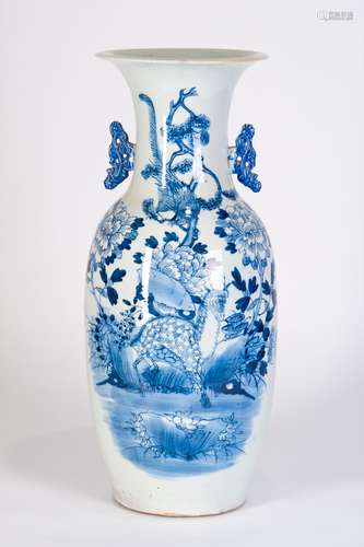 A BLUE AND WHITE VASE WITH FLOWERS AND DEER