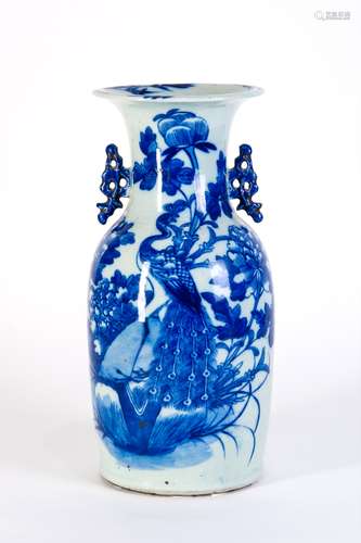 A BLUE AND WHITE VASE WITH PEACOCK