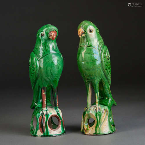 A PAIR OF GREEN GLAZED PORCELAIN PARROTS