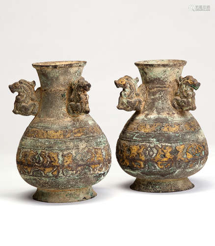 A PAIR OF GILT COPPER POTS WITH THREE EARS