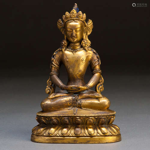 A GILT CARVED COPPER FIGURE