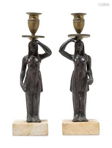 A Pair of Bronze Figural Candlesticks