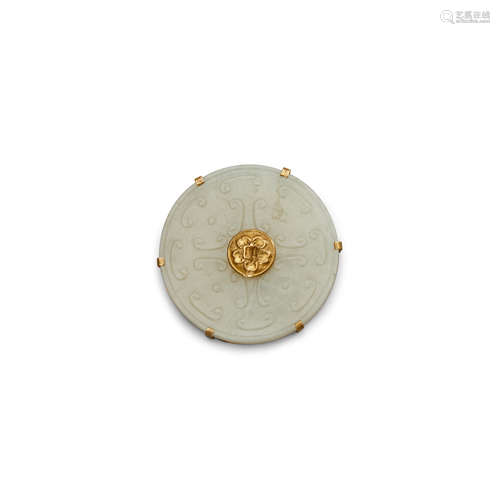 The jade, Late Qing/Republic period A carved jade bi disc in a gilt metal mount