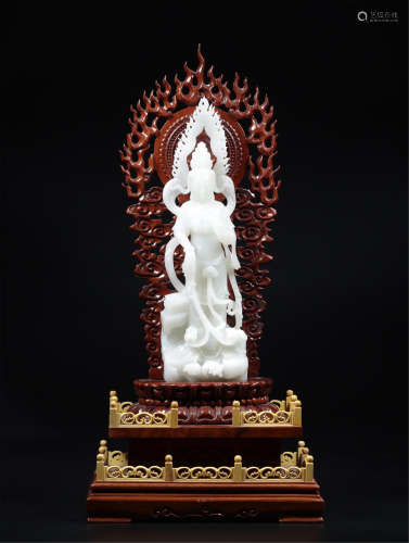 A CHINESE CARVED WHITE JADE STANDING GUANYIN WITH BASE