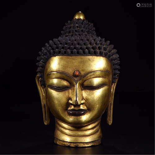 A CHINESE GILT BRONZE SAKAYMUNI HEAD