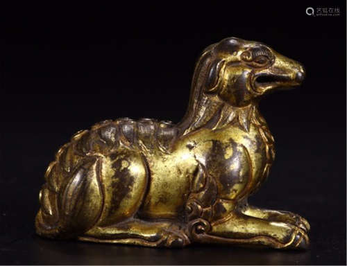A CHINESE CARVED GILT BRONZE BEAST TABLE ITEM