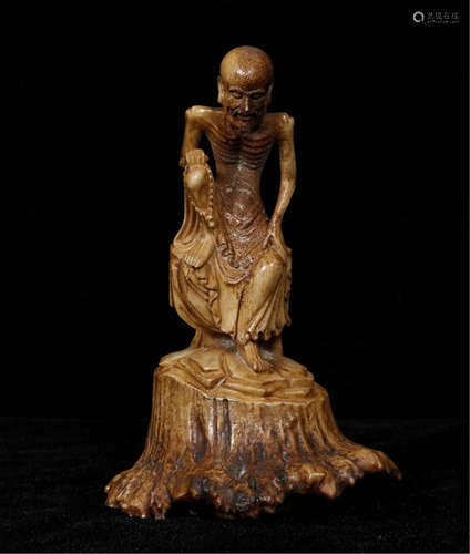 A CHINESE CARVED STANDING LOHAN