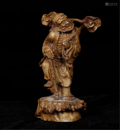 A CHINESE CARVED STANDING IMMORTAL