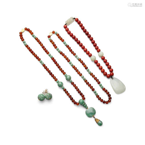 A group of three necklaces and a jadeite earring