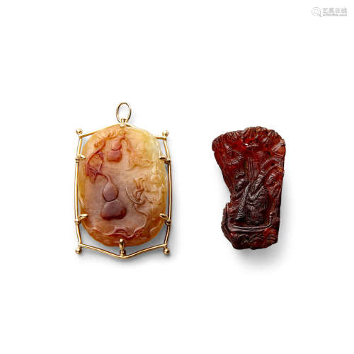 A mounted carved jade pendant and a small amber carving