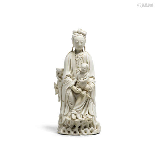 19th century A Dehua porcelain figure of a seated Guanyin with child