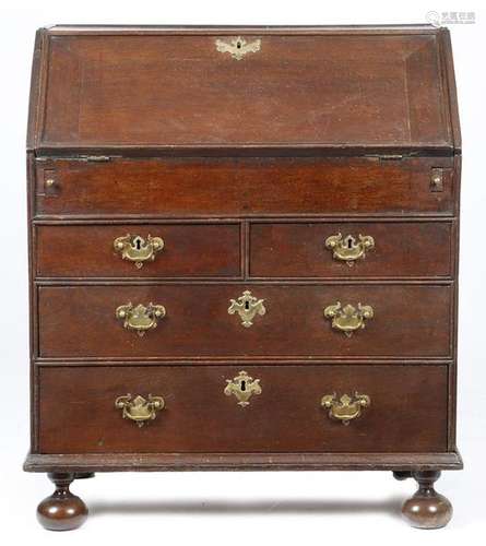 An early 18th century oak bureau, the hinged fall …