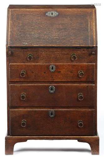 A small George II oak bureau, the hinged fall reve…