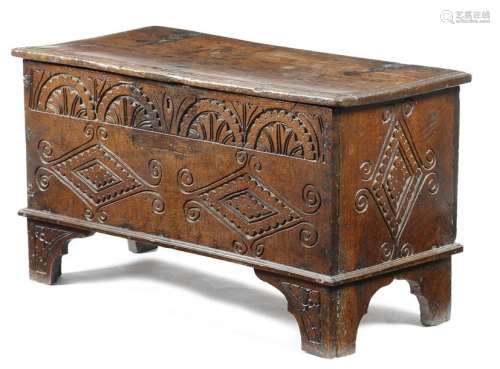 A carved oak coffer, the hinged lid revealing a va…