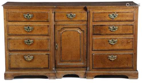 A George III oak inverted breakfront dresser, with…
