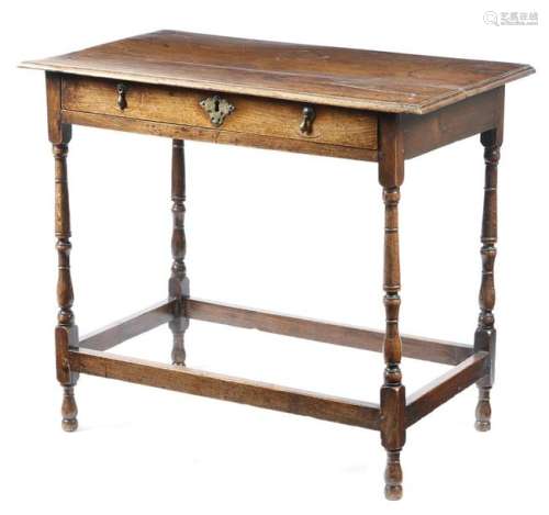 An early 18th century oak side table, the boarded …