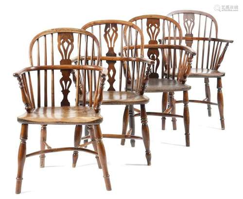 Four Victorian yew lowback Windsor armchairs, each…