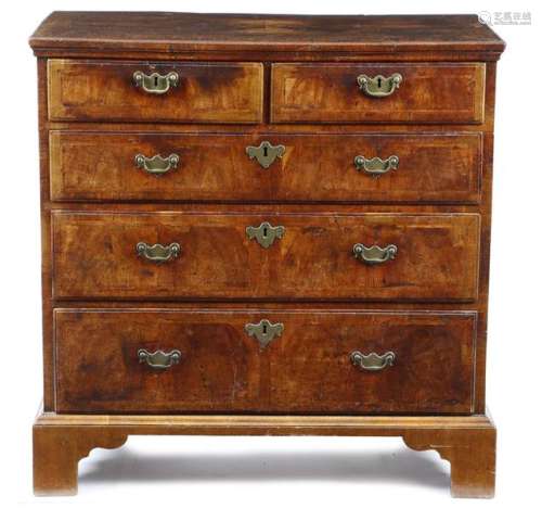 A George II walnut chest, the quarter veneered top…