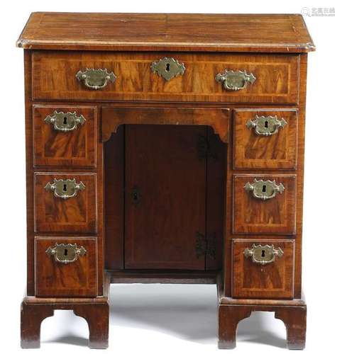 A George II walnut kneehole desk, the quarter vene…