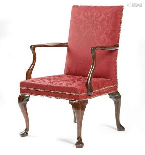 A George II walnut open armchair, the padded back …