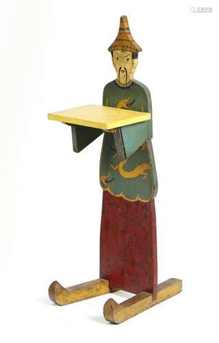 A painted wood shop sign in the form of a Chinaman…