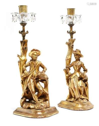 A pair of carved giltwood candlesticks in 18th cen…