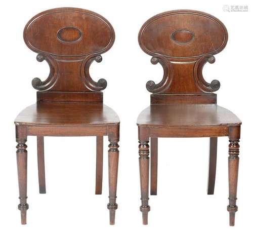 A pair of Regency mahogany hall chairs, each with …