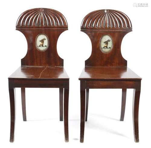 A pair of Regency mahogany hall chairs, each with …