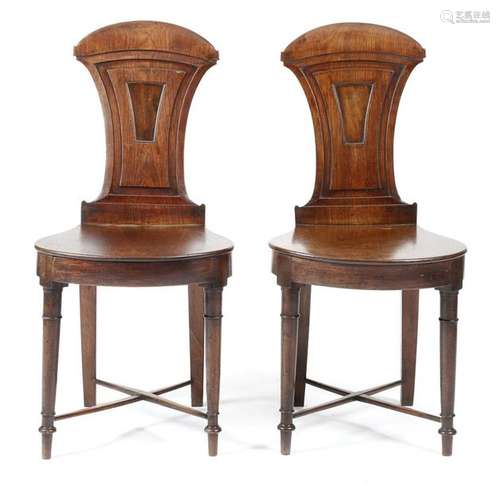 A pair of Regency mahogany hall chairs, each with …