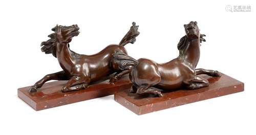 A pair of French Charles X bronze models of recumb…