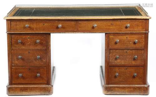 A Victorian oak twin pedestal desk, the top with a…